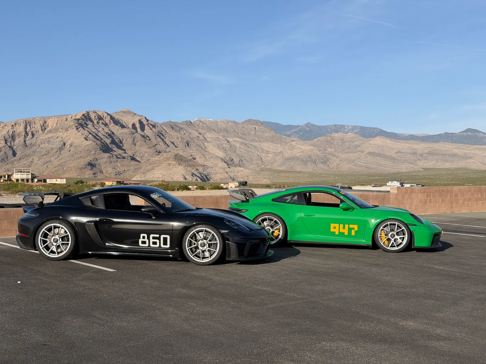 LTB Racing founders' own Porsches — a black 718 GT4RS and a python green 992 GT3